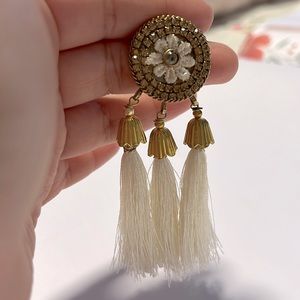 cream long tassel earrings on gold